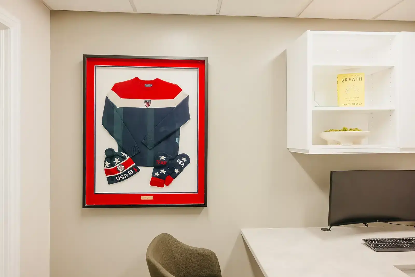 Framed Team USA memorabilia displayed in the Advanced Dentistry and Aesthetics office